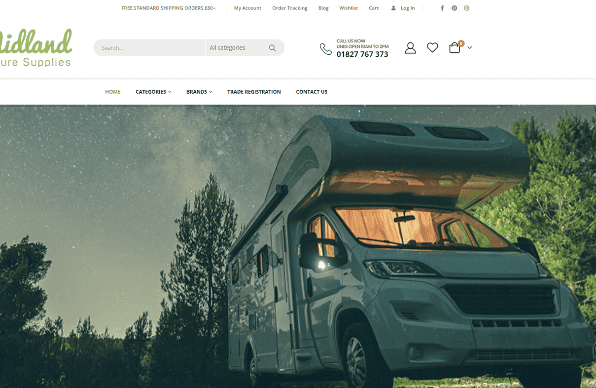 Motorhome in a lush green outdoor environment with trees and a starry sky background.