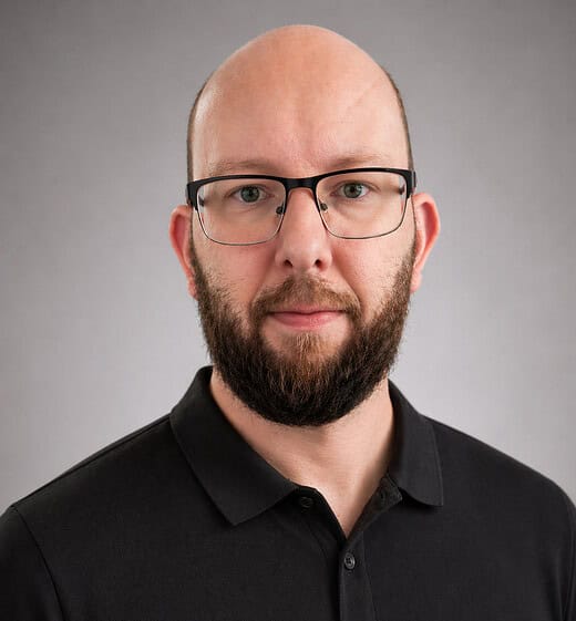 Expand Digital Media professional headshot with a man wearing glasses and a black polo shirt.